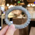 Grey satin hair scrunchie detail view showing soft fabric texture and elegant beaded accent. - S / Blue Gray