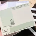 Detailed close-up view of the 10x14cm green memo pad featuring dog art and text. - Green