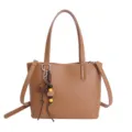 Brown leather tote shoulder bag for women, stylish commuting handbag with decorative charm. - Brown