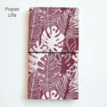 Portable plant pattern traveler notebook with elastic band for daily journaling and writing. - Burgundy Tropical