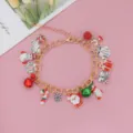 Braccialetto con charms di Natale con Babbo Natale pupazzo di neve e regali, gioielli dorati. - Oro