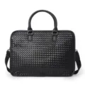 Detailed view of the black woven leather business briefcase showing fine texture and premium handles. - Black Woven Bag