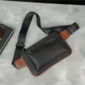 Detailed view of trendy men's black and brown crossbody chest bag, adjustable strap design. - Black and Brown