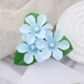 Close-up detail of the blue fabric flower hair clip with pearl center, delicate leaf design. - Light Blue