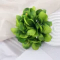 Green artificial flower hair clip detail, multi-layered fabric petals for beach vacation. - Verdant