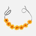 Detailed view of yellow artificial rose hairband with black cord and metal beads. - Orange