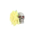 Yellow rose skull hair clip detail showcasing red rhinestone eyes and velvet fabric texture. - Yellow