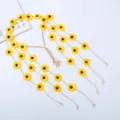 Close-up of yellow sunflower floral headband with delicate tassels and wooden beads. - Yellow