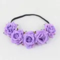 Closeup view of purple rose floral headband with black elastic band for party hair decor. - Violet