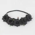 Detailed view of the black rose floral headband, showing fabric flowers and elastic band. - Black