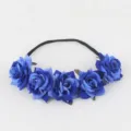 Blue rose floral headband detail showing artificial velvet flowers and black elastic band. - Sapphire Blue