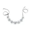 Detailed close-up of the silver fabric flower hairband, showing the delicate petals and cord. - Silver