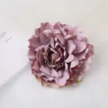 Closeup detail of an artificial dusty purple peony flower head, soft petal texture. - Grey Purple