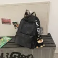 Black canvas backpack for students, stylish college style casual travel daypack with cute dog charm - With Puppy Pendant / Black