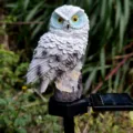 Solar owl garden light detail view, resin animal lawn stake lighting for outdoor yard. - White with Blue Eyes