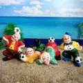 Detailed view of miniature clown figurines playing soccer on sand, ideal for sand tray therapy. - Clown Ornament