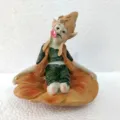 Close-up detail of the resin goblin fairy figurine sitting on flower base with cute expression. - Troll Style A