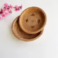Detailed view of handmade woven round rattan basket storage tray, natural rustic home decor. - Cross-Pattern Storage Basket 2-Piece Set / Accessories Duo / Brownish Yellow