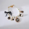 Vintage pet pearl necklace with bow crown and charms, elegant dog collar accessory. - S / Black