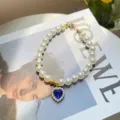 Cute pet pearl necklace with blue heart crystal pendant, stylish cat collar accessory for photos. - Dark Blue Gem