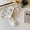 White mid-tube cotton socks featuring a stylish embroidered patch, breathable and comfortable street style. - One Size / NO White