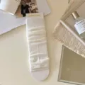 White knitted stirrup leg warmers slouch socks, cozy fashion footwear accessory. - White