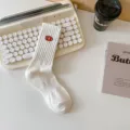 White ribbed mid-calf cotton socks featuring a stylish embroidered football motif for everyday wear. - One Size / B White