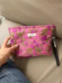 Close-up detail of the pink floral cosmetic bag showing elegant fabric texture and brand label. - L / Rose Red Lychee Flower