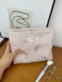 Close-up of pink embossed rose cosmetic bag detail, showing fine embroidered texture. - Embossed Rose Pink Large