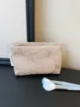 Satin cosmetic bag featuring delicate 3D rose embroidery, perfect for travel and daily storage. - Embossed Rose Pink Medium