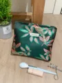 Close-up detail of embroidered floral cosmetic pouch in dark green satin material. - L / Green Base Pink Floral Large