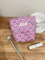 Detail shot of purple jacquard cosmetic bag featuring pink flower pattern and portable drawstring. - S / Pink Small Floral