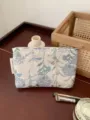 Detailed view of fresh floral print cosmetic pouch, portable travel makeup storage bag. - M / Light Blue