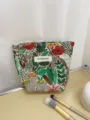 Detailed close-up of the vintage embroidered floral makeup bag showing intricate fabric texture. - S / Green Forest