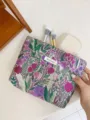 Detailed view of large capacity floral embroidered makeup bag, portable cosmetic storage organizer. - L / Purple Forest Floral