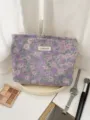 Detail view of purple floral jacquard cosmetic pouch, elegant fabric texture for travel use. - L / Purple Little Flower