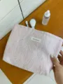 Pink embossed cosmetic bag detail shot, textured travel makeup pouch for daily storage. - L / Pink