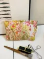 Detail view of floral canvas makeup bag, large capacity cosmetic pouch with zipper for women. - M / Floral Jungle