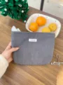 Detailed view of gray corduroy cosmetic bag, soft textured travel makeup pouch and storage. - Gray
