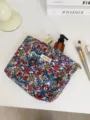 Detail view of the vintage floral cosmetic bag, showing fabric texture and zipper pocket. - L / Vintage Blue Red