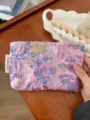 Purple embossed floral cosmetic pouch detail shot, portable travel makeup storage bag. - Embossed Flowers / M / Purple