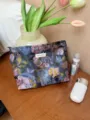 Detail view of floral jacquard cosmetic pouch with dark retro pattern and zipper closure. - L / Blue-Purple Oil Painting
