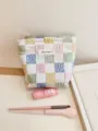 Detail view of the pastel checkerboard cosmetic bag with embroidered flower patterns. - S / White with Colorful Grid