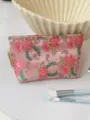 Close-up detail of the pink floral embroidered cosmetic pouch showing fine fabric texture. - M / Red Flower Green Vine