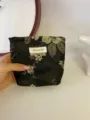 Close-up detail of the black and gold floral makeup bag, vintage fabric pouch and storage case. - S / Black Floral
