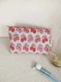 Detailed view of cute strawberry print canvas makeup pouch, ideal portable travel storage bag. - M / Pink
