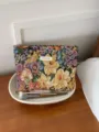 Close-up detail of the elegant floral embroidered jacquard makeup storage pouch placed on wooden desk. - L / Colorful Jungle