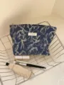 Denim cosmetic bag with elegant white floral print, large capacity and portable zipper design. - L / Blue Floral