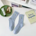 Light blue cotton mid-tube socks featuring cute lettuce edge and sweet tulip embroidery. - One Size / Blue