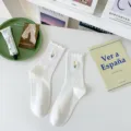 White cotton mid-calf socks featuring delicate lettuce edges and cute yellow tulip embroidery. - One Size / White